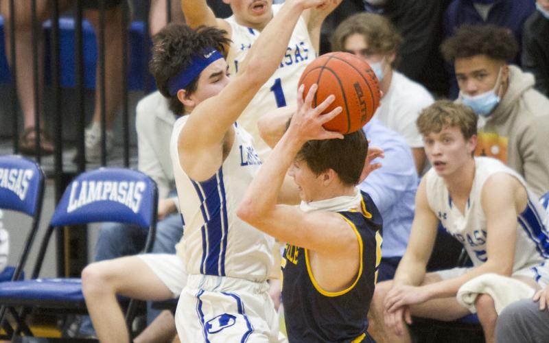 Tak Stinnett, front-left, and Anthony Ortiz close in on a Stephenville player.