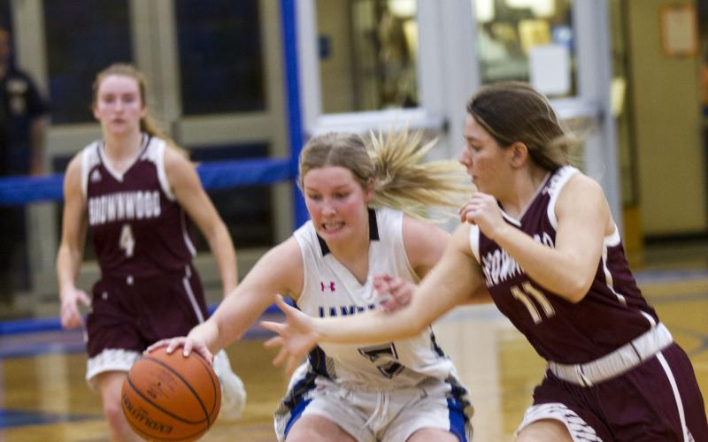 Laurcy Bender protects the ball as a Brownwood defender closes in.