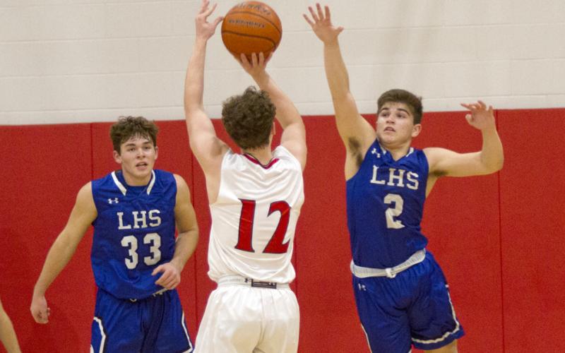 Dax Brookreson (2) and Carter Johnson (33) defend against an Eagle shot.