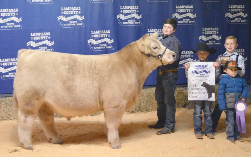 Ridge Hill, (in center, next to steer), is shown with his brothers Trigg, Housten and Judd.