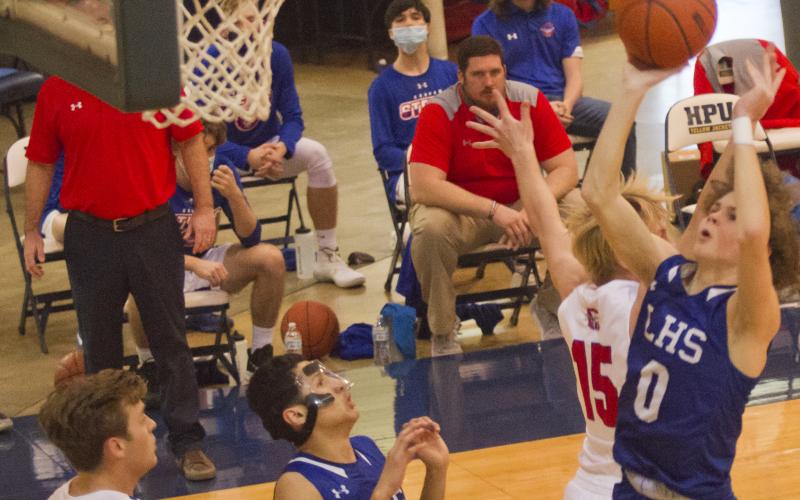 Nate Borchardt drives to the basket while Jacob Hogeda (3) gets in position for a rebound.