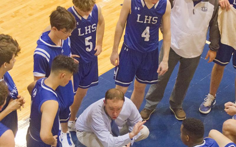 The Badgers meet during a timeout in the second half.
