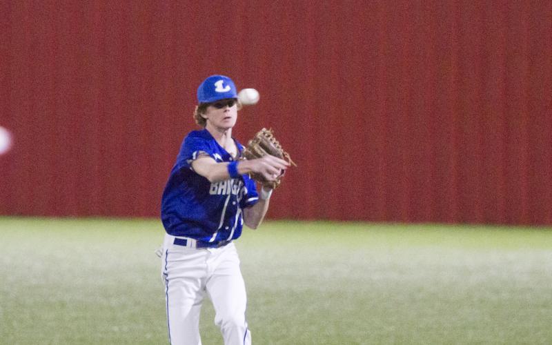 Nate Borchardt makes a throw to first after fielding the ball in Tuesday's district victory.