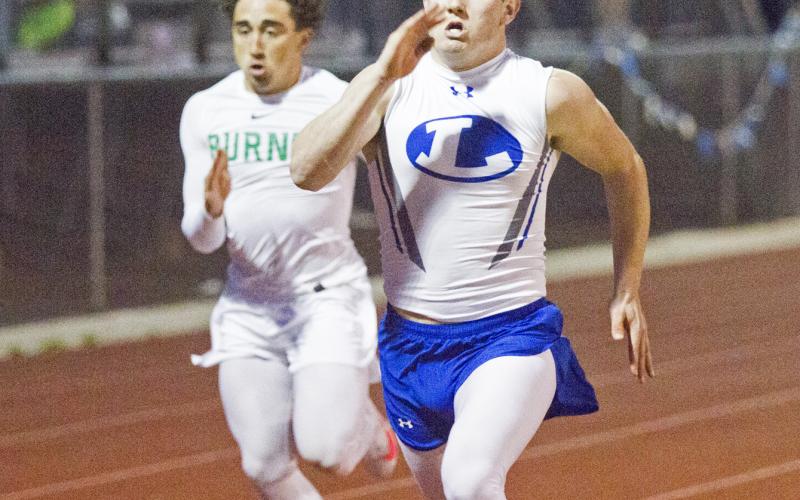 Case Brister sprints in the 100-yard dash. Brister earned a silver medal in that event after winning pole vault.