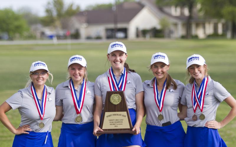 Lady Badger golfers Elizabeth Cross, LeeAnn Parker, Kinsley Lindeman, Shaylee Wolfe and Kylee Rutledge show the first-place team plaque they earned on April 5 and April 12 in a 36-hole district tournament.