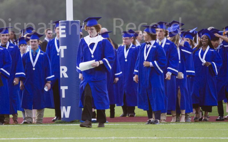 Seniors line up in the end zone at the start of Lampasas High School graduation on Friday at the turf field.