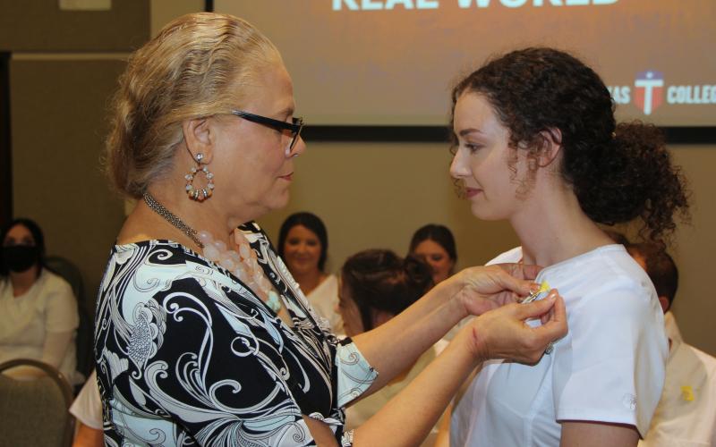  Louise Perry, Central Texas College nursing professor presents a student their nursing pin during the fall 2021 licensed vocational nursing pinning ceremony. | Courtesy Photo
