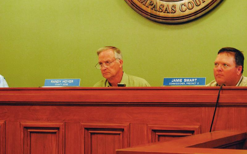 County Judge Randy Hoyer and Commissioner Jamie Smart listen to discussion on the county's burn ban.