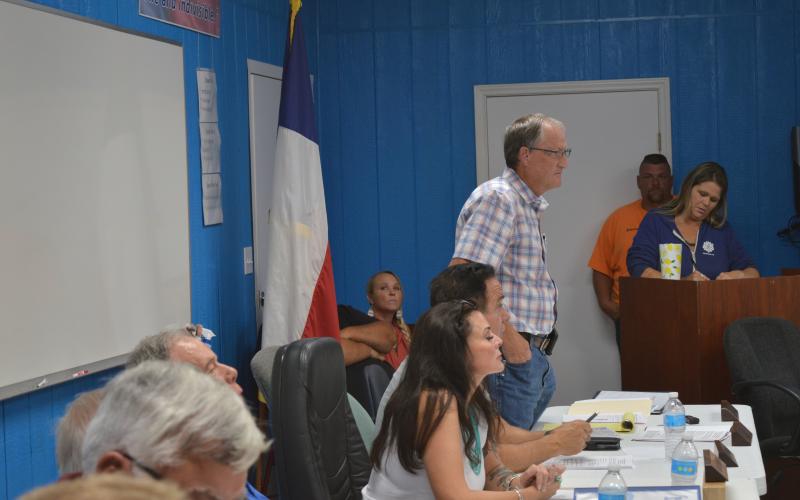KWSC General Manager stands to speak during the boarding meeting.