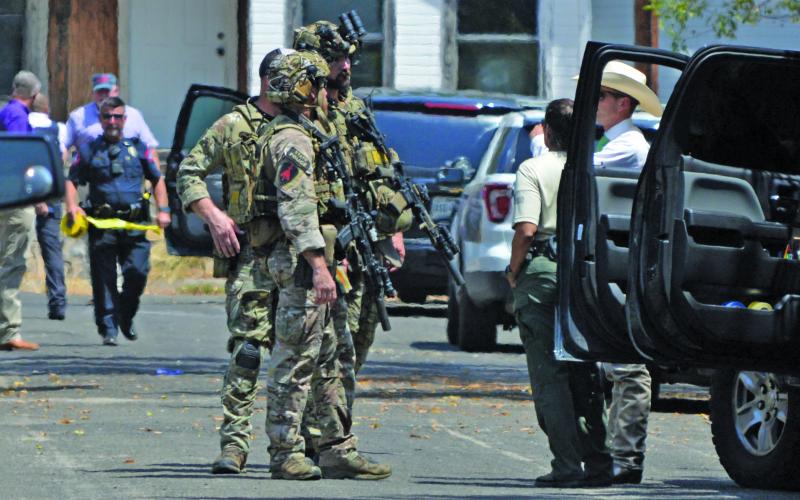 Texas DPS Swat stands by as Lampasas Police tape a perimeter around the incidence scene.