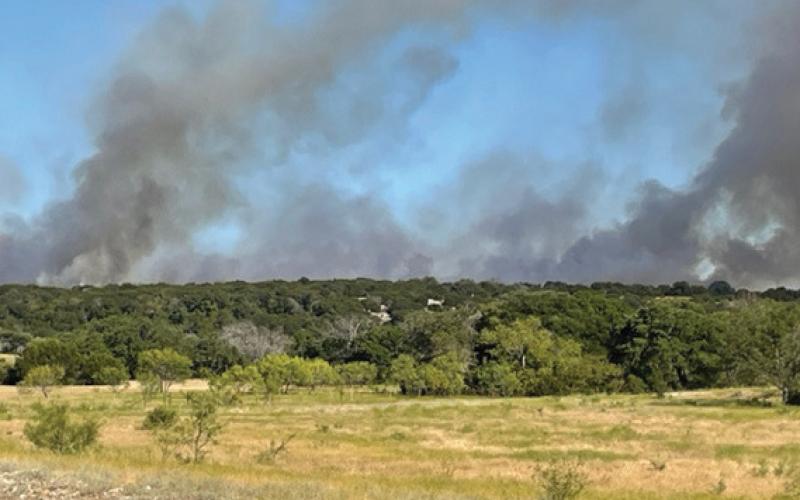 Smoke rises from the Spotted Opossum Fire northeast of Adamsville.