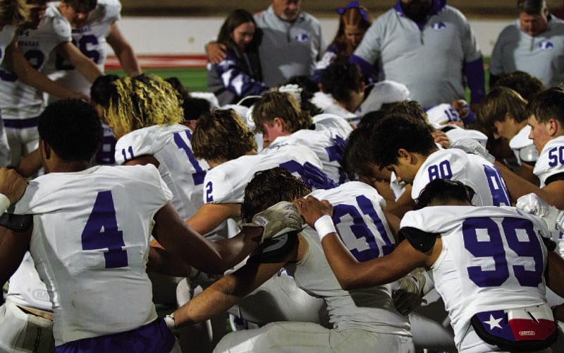 Players and coaches gather around each other after finishing a successful 10-3 season in 2024.
