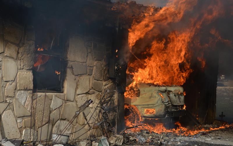 A motor vehicle is engulfed in flames during a structure fire at 778 County Road 4804 on Tuesday afternoon. The incident led to the death of a 71-year-old woman.  ERICK MITCHELL | DISPATCH DISPATCH