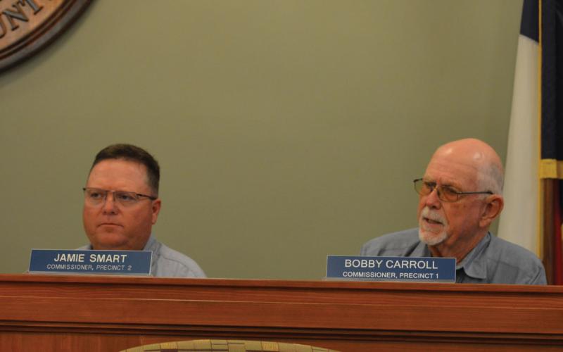 From left, Precinct 1 Commissioner Jamie Smart and Precinct 2 Bobby Carroll talk flood damage during today's Lampasas County Commissioners Court regular meeting. ERICK MITCHELL | Dispatch Record