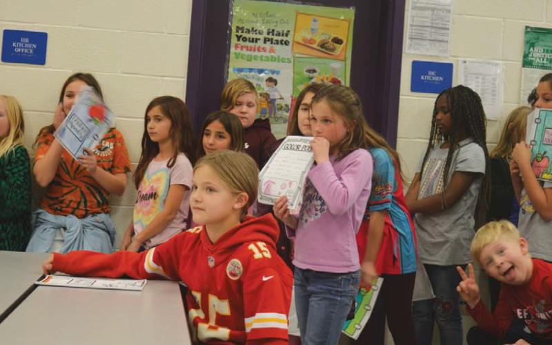 Taylor Creek fourth-grade students watch as classmates deliver their poetry creations. erick mitchell | dispatch record