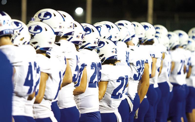 HUNTER KING | DISPATCH RECORD The Badger football team stands on the sideline prior to the start of their area-round playoff game against Alice.