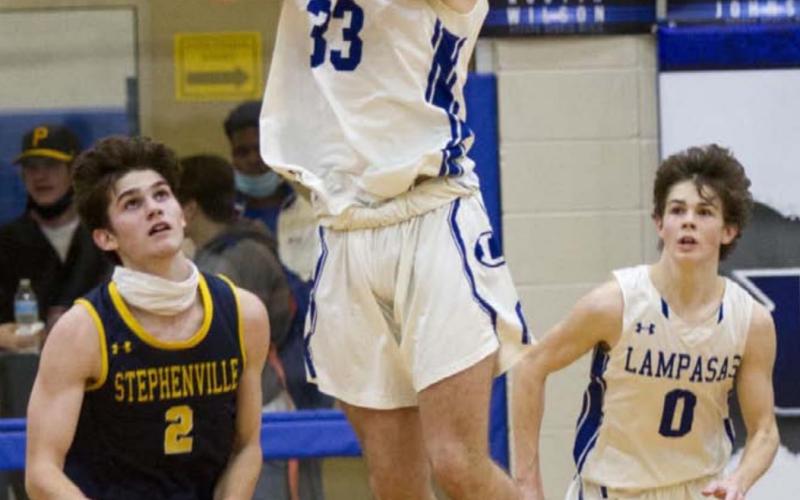 Carter Johnson (33) recovers the ball after blocking a three-pointer in the fourth quarter, while Nate Borchardt (0) goes in transition. JEFF LOWE | DISPATCH RECORD