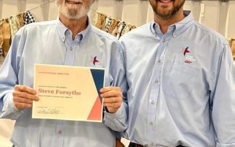 Dr. Steve Forsythe, left, was recognized by Lampasas County Farm Bureau President Heston McBride for Forsythe’s public relations efforts in promoting the county Farm Bureau’s program of work. Courtesy photo