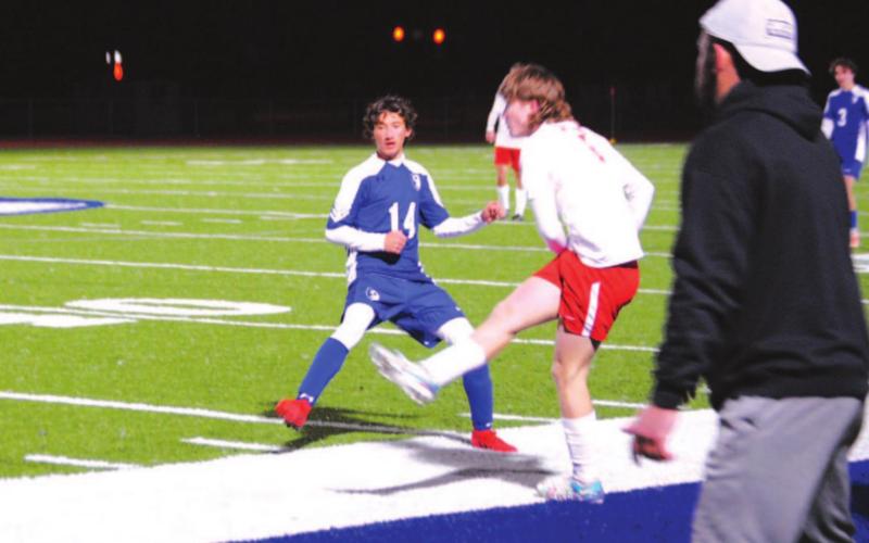 Tyler Ecker puts a foot into a challenge against Salado on Friday night. Head coach Samuel Burnside looks on. HUNTER KING | DISPATCH RECORD