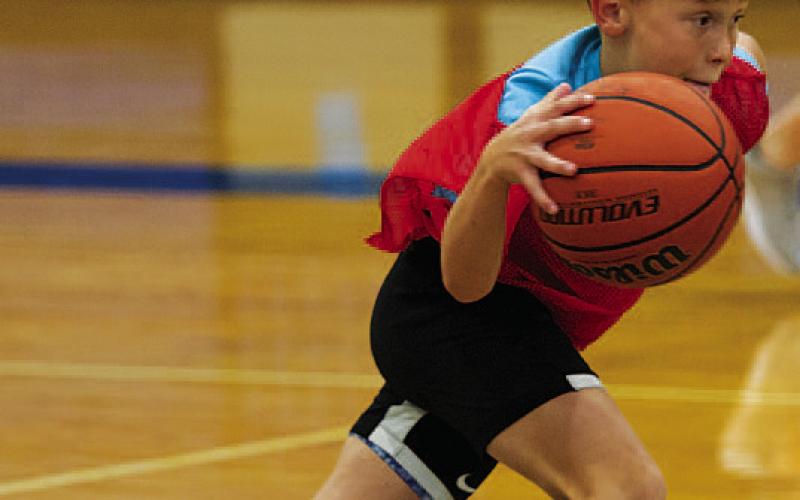Ayson Nuckles drives past a defender at youth basketball camp. HUNTER KING | DISPATCH RECORD