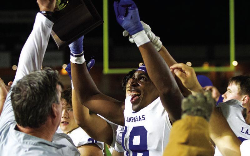 Trenton Hobbs smiles at the new trophy the Badgers won last Friday. HUNTER KING | DISPATCH RECORD