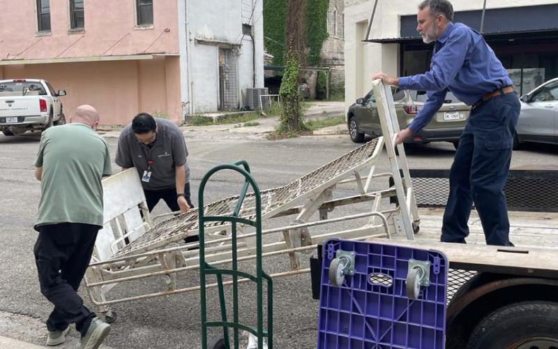 Shown left to right are Chance Carter, Rudy Rodriguez and Keith Russom as they load the antique hospital bed onto a flatbed for transport from the museum to the hospital. courtesy photo