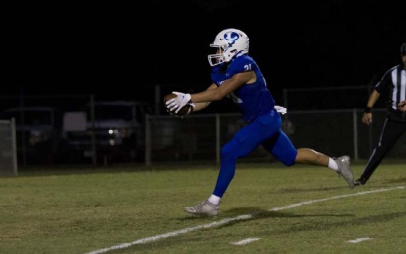 Ethan Moreno reaches for the goal line for one of his four touchdowns of the night during the Badgers’ rout of Elgin on Friday. HUNTER KING | DISPATCH RECORD