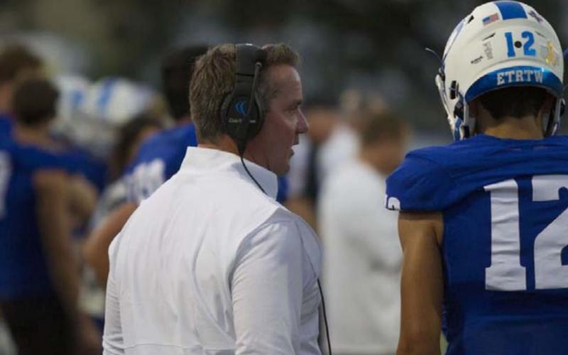 Head Coach Troy Rogers speaks to his quarterback Dylan Sanchez on the sideline during the Elgin game. HUNTER KING | DISPATCH RECORD