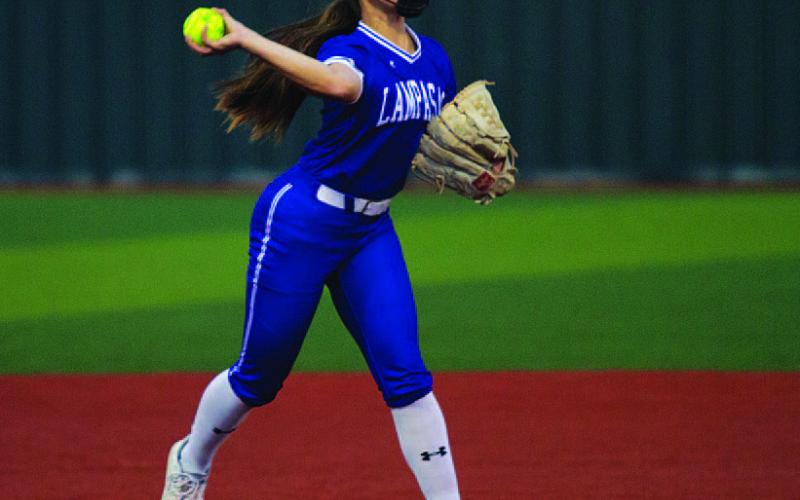 HUNTER KING | DISPATCH RECORD Hadlie Perry makes a throw across the diamond against Jarrell.
