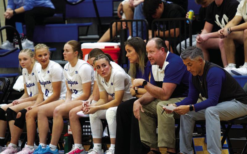 The Lady Badgers and their coaches look on during Tuesday’s game against Rogers.