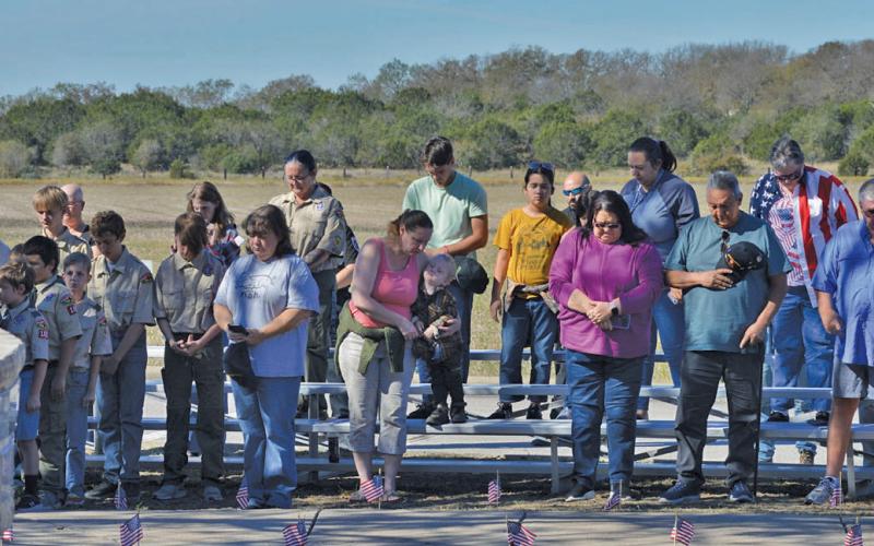 Erick Mitchell | dispatch record Kempner residents close their eyes in a moment of prayer during Monday’s Veterans Day ceremony at Sylvia Tucker Memorial Park.