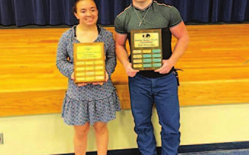 Brianna Miller, left, and Westen Reid pose with their Battlin’ Badger trophies at the powerlifting banquet. COURTESY PHOTO
