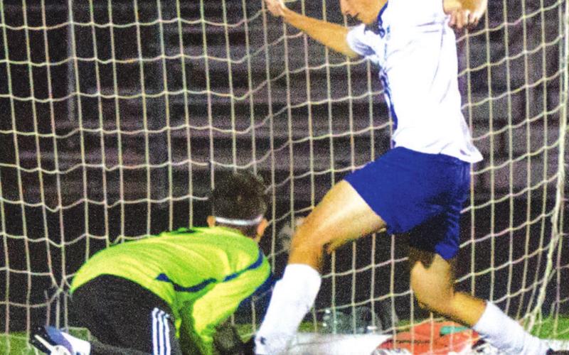 Landon Richardson pokes a goal home during the Badgers’ playoff matchup last year. FILE PHOTO