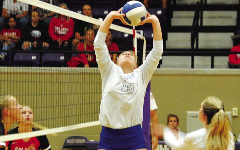 Ava Dowdy sets the ball for Breana Pelbath during Tuesday’s playoff match. HUNTER KING | DISPATCH RECORD