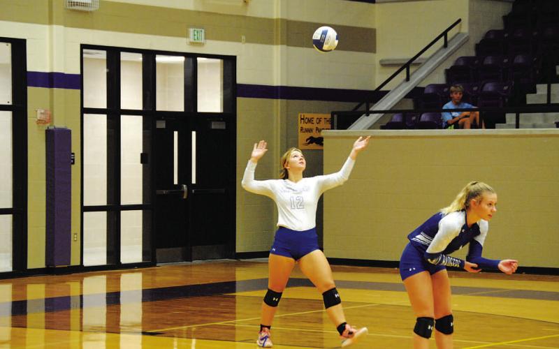 Maggie Fletcher serves as Bre Quarles stands in position against Salado in the playoffs. HUNTER KING | DISPATCH RECORD