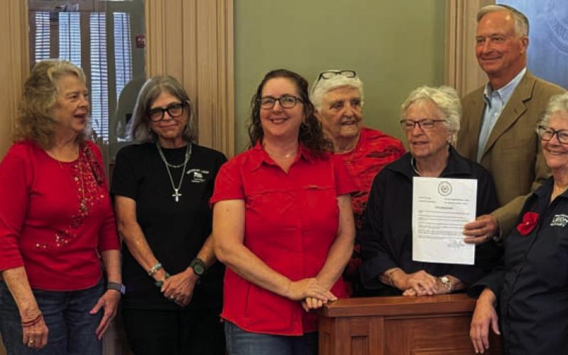 ERICK MITCHELL | DISPATCH RECORD County Judge Randy Hoyer presents a Poppy Day proclamation from the Lampasas County Commissioners Court to a group of representatives from the Briggs-Wright American Legion Post 277 Auxiliary of Lampasas. Poppy Day will be recognized May 22, when residents are invited to wear a red poppy to honor those who lost their lives fighting for our freedom.