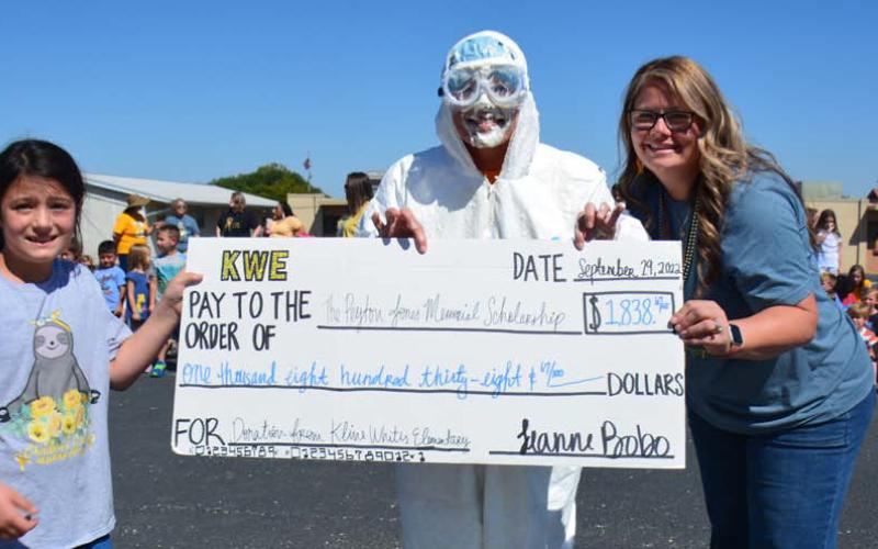 Kline Whitis Elementary School students raised more than $1,800 for the Peyton Jones Memorial Scholarship that will help two Lampasas High School students further their college education. Pictured are Jones’ 8-year-old sister Evalynn Seward, Principal Leanne Bobo and Jones’ mother, educator Shante Seward. The LHS student died of leukemia in 2018. MONIQUE BRAND | DISPATCH RECORD
