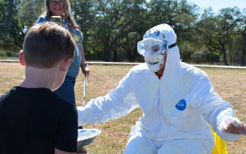 Kline Whitis Prinicpal Leanne Bobo gets a pie in the face by kindergartener Maverick Summers, as part of a fundraiser for the Peyton Jones Memorial Scholarship. Summers raised the most out of all the participants, about $100. MONIQUE BRAND | DISPATCH RECORD