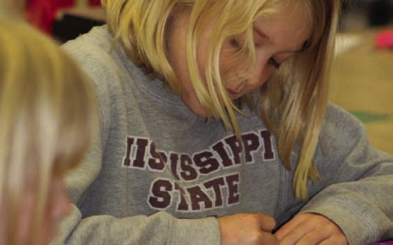 Hadley Crawford is busy preparing her strips of “protein” that will make a model of a double-helix DNA strand. The library hosted a STEAM event on “Heart and Lungs: Working Together.” JOYCESARAH MCCABE | DISPATCH RECORD