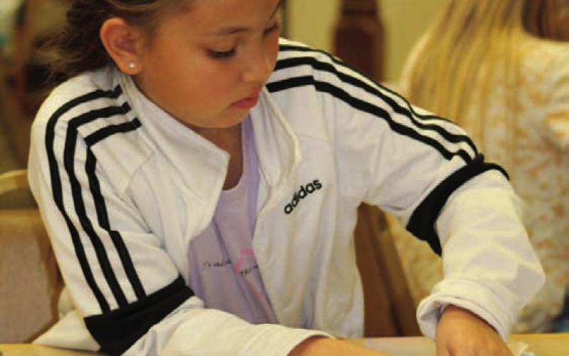 Seven-year-old Mikayla Cordova inserts strips of paper “proteins” to create a paper model of a double-helix DNA at the STEAM event held Tuesday at Lampasas Public Library. JOYCESARAH MCCABE | DISPATCH RECORD