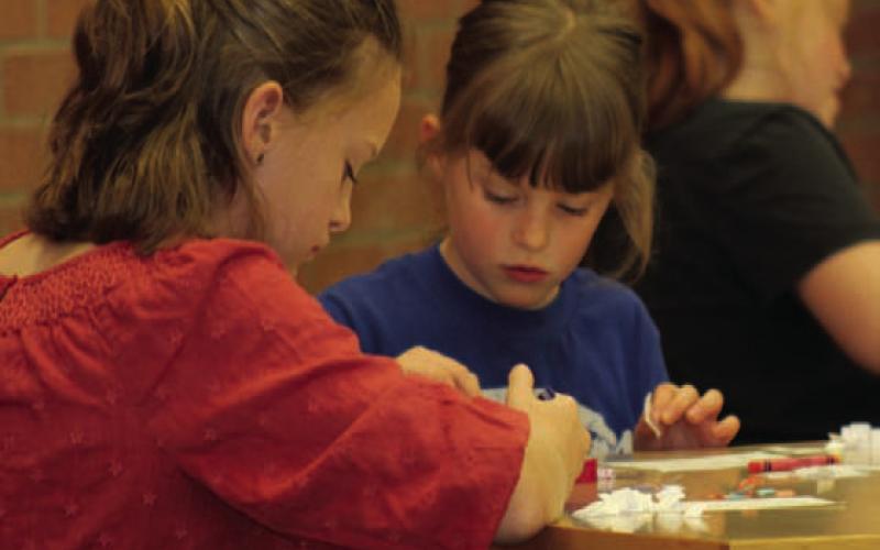 Vivien Martin and Madeline Martin work hard creating a paper model of double-helix DNA during the Lampasas Public Library’s STEAM event Tuesday. JOYCESARAH MCCABE | DISPATCH RECORD