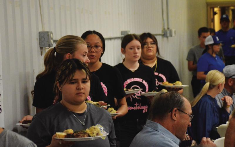 Lampasas High School CTE students serve attendees their meal during Saturday’s dinner fundraiser hosted by Creating Badger Builders. HUNTER KING | DISPATCH RECORD