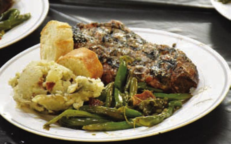 Participants enjoyed a pork chop meal at Saturday’s event. HUNTER KING | DISPATCH RECORD