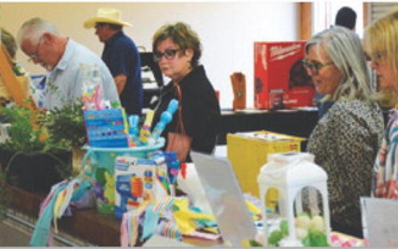 Attendees at Creating Badger Builders’ annual dinner and fundraiser scope out the silent auction offerings, which were crafted by students in various CTE programs. HUNTER KING | DISPATCH RECORD
