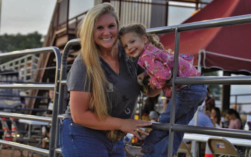 Friday’s Riata Roundup Rodeo provided a night of family fun. From left, Kaila and Wren Rogers pose for a photo just outside the 580 Sports Park rodeo arena. ERICK MITCHELL | DISPATCH RECORD