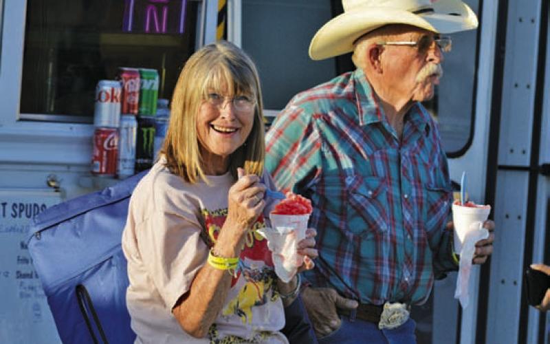 Kathie and Richard Andrews enjoy some refreshing snow cones before watching Riata Roundup Rodeo action hosted by the County of Lampasas Rodeo Association. ERICK MITCHELL | DISPATCH RECORD