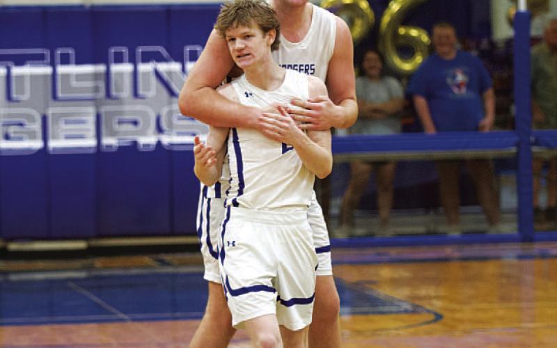 HUNTER KING | DISPATCH RECORD Beau Patterson hugs Peyton Sisson after the final buzzer sounds in the win over Gateway.