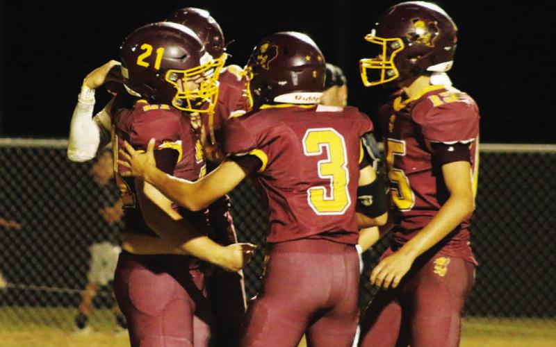 Lometa quarterback Jordan Livesay (3) and running back Carson Brister (15) celebrate in the end zone following Roy Carr’s (21) touchdown reception for the Hornets. MASON HINES | DISPATCH RECORD