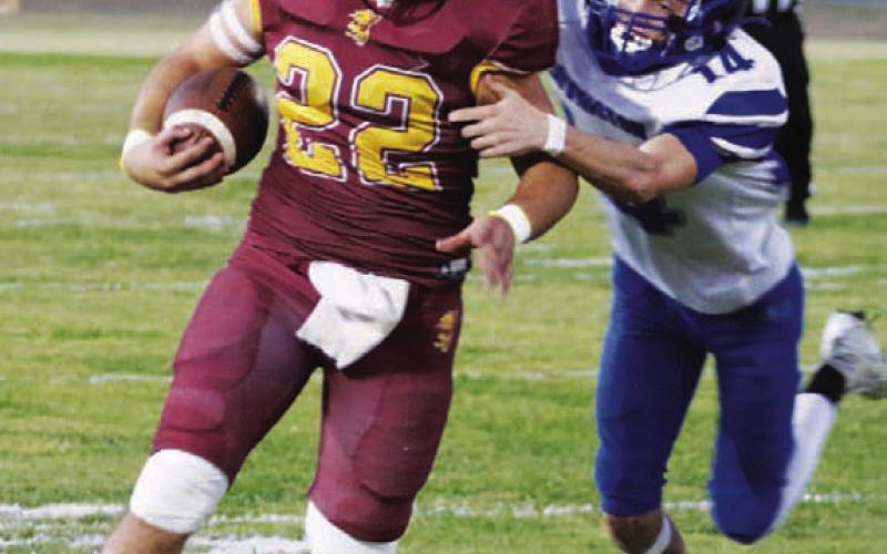 MASON HINES | DISPATCH RECORD Lukas Smailus-Cruz heads upfield on one of his two touchdown runs during Friday’s 67-14 win.