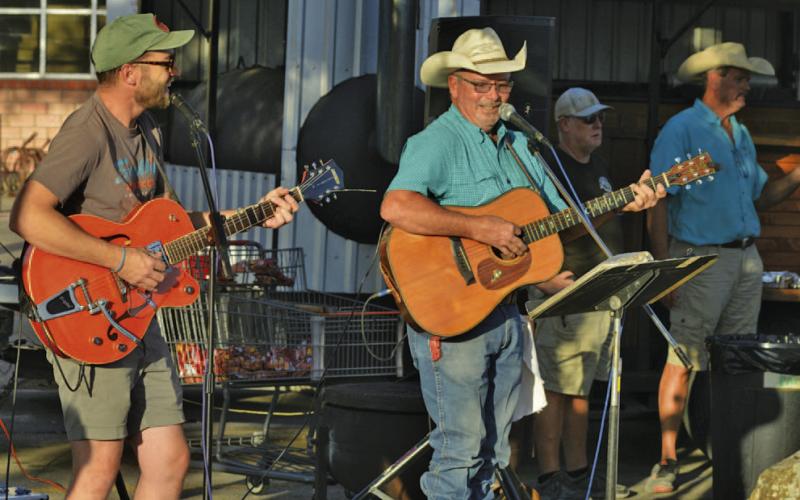 Zach Huckabee, at left, and Roland Schaub provide tunes during Tuesday’s National Night Out. ERICK MITHCELL | DISPATCH RECORD